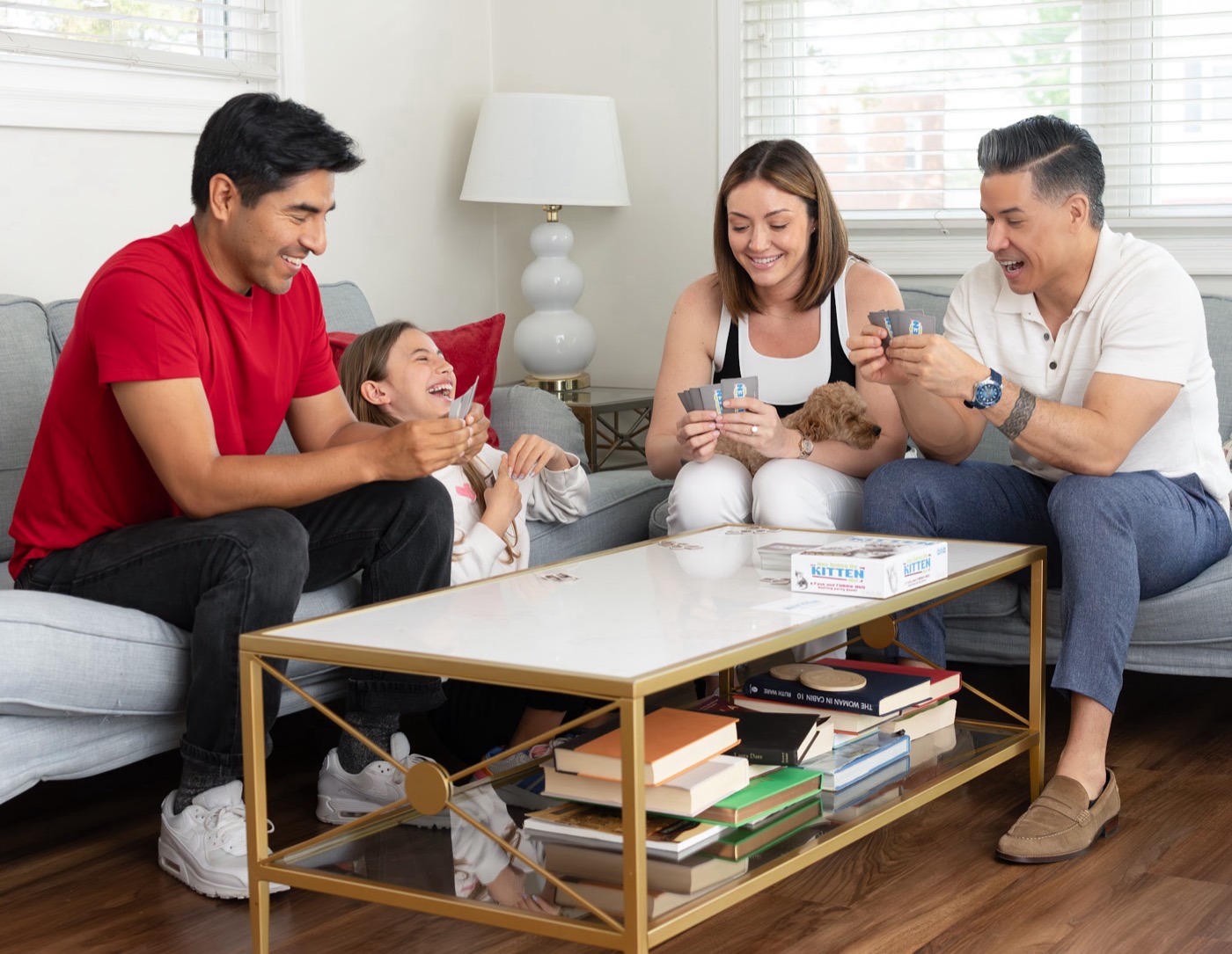 A family laughing while playing You Gotta Be Kitten Me!